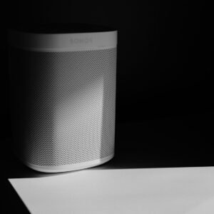 a white speaker sitting on top of a table